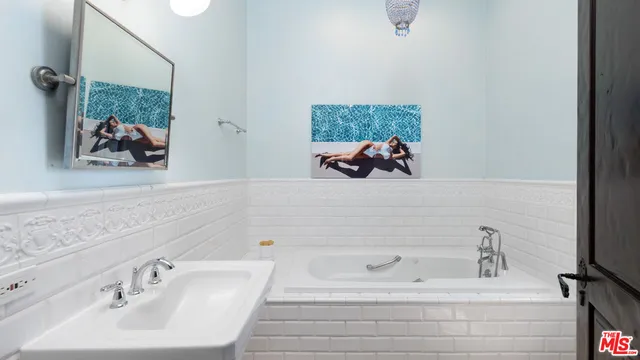 a view of a backyard with potted plants and large trees