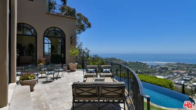 a view of a yard with wooden fence