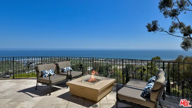 a view of a lush green hillside and a house