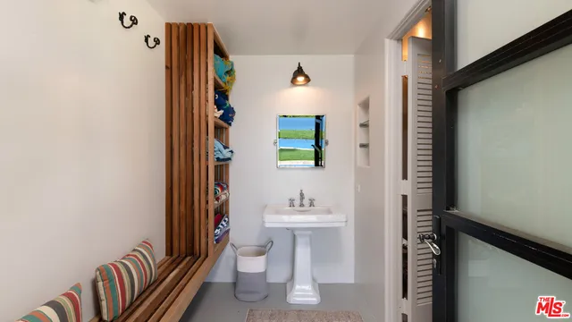 a view of hall way with furniture and front door