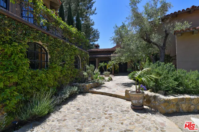 a view of a patio with table and chairs and potted plants