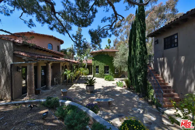 a living room with furniture fireplace and a large window
