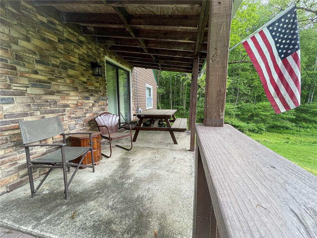 141 Minich Road Butler, PA 16001 - Photo 4 of 26 a view of a patio with table and chairs with wooden floor and fence
