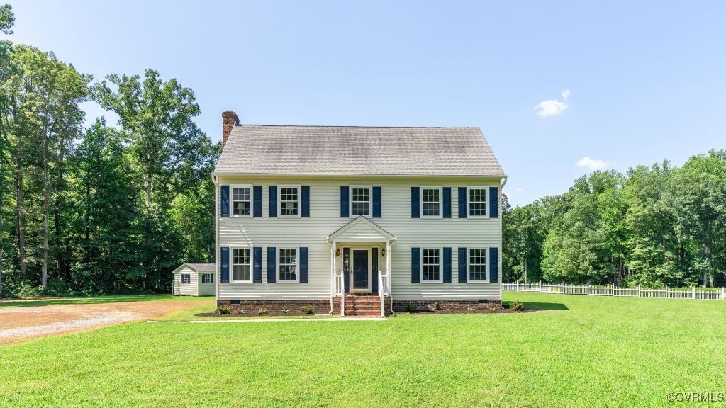 a front view of a house with a garden and yard