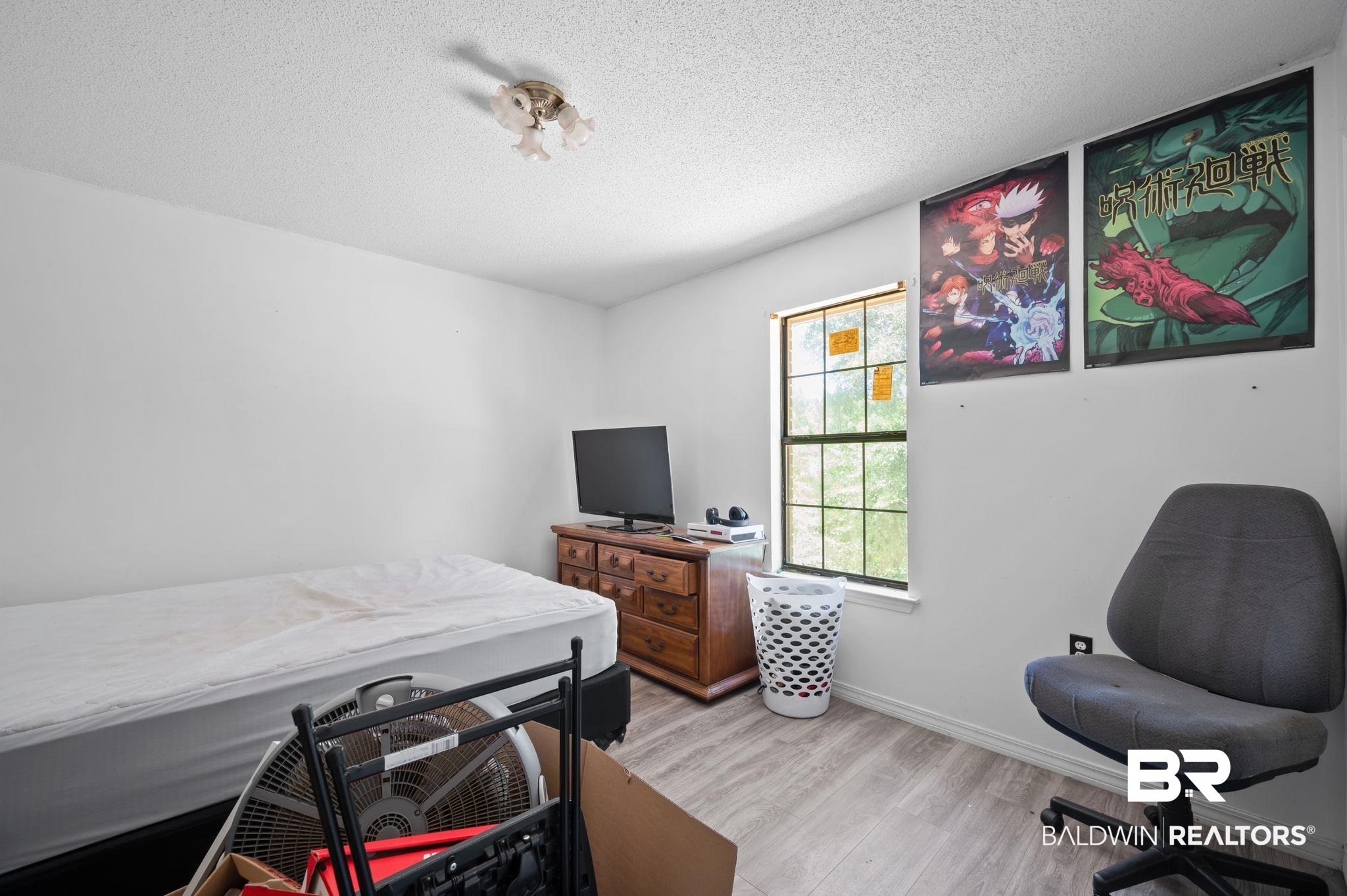 52923 Ammons Road Perdido, AL 36562 - Photo 19 of 35 Bedroom featuring light wood-style floors, a textured ceiling, and an office area