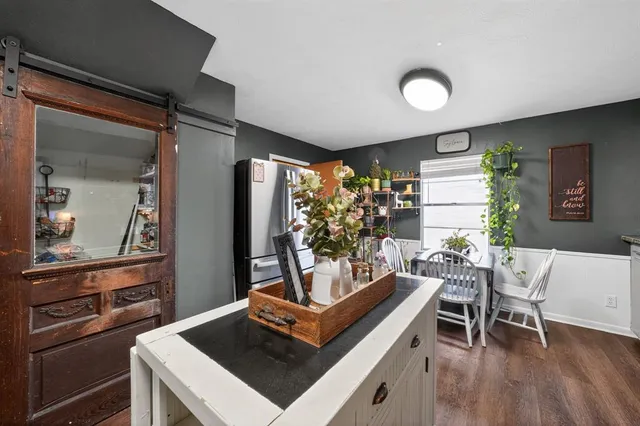 a view of a dining room with furniture and chandelier