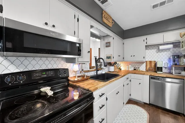 a kitchen with a stove and a microwave