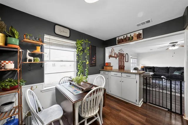 a kitchen with a table chairs stove and cabinets
