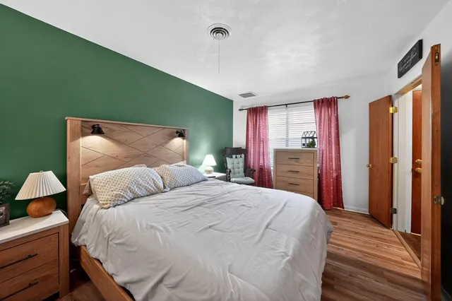 a bedroom with a large bed and a dresser