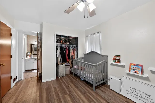 a view of a bedroom with furniture and wooden floor