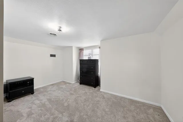 a view of an empty room with a fireplace