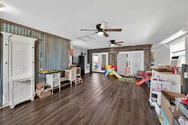 a view of a livingroom with furniture and hardwood floor