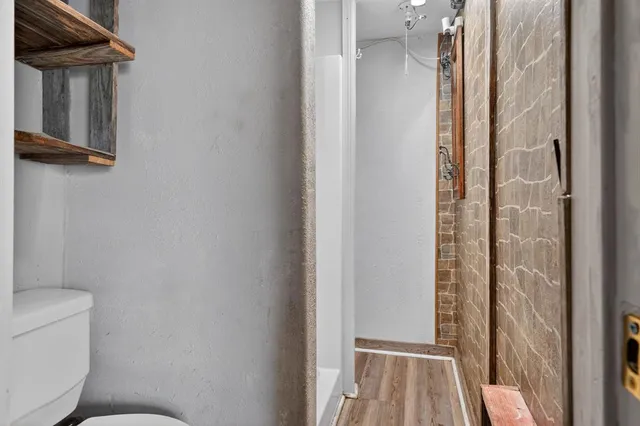 a bathroom with a toilet and a shower