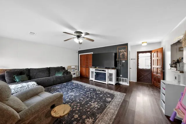 a living room with furniture and a flat screen tv