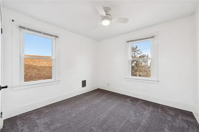 an empty room with windows and closet