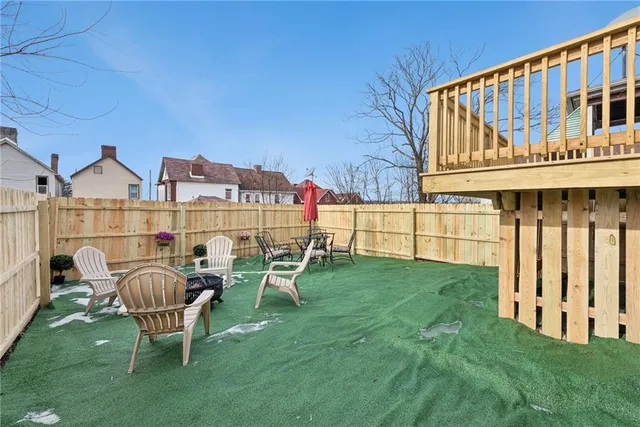 a view of a chair and table in the backyard