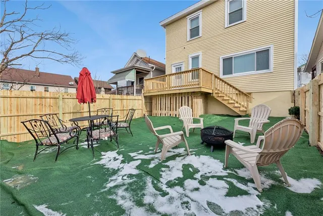 a view of a house with backyard sitting area and entertaining space