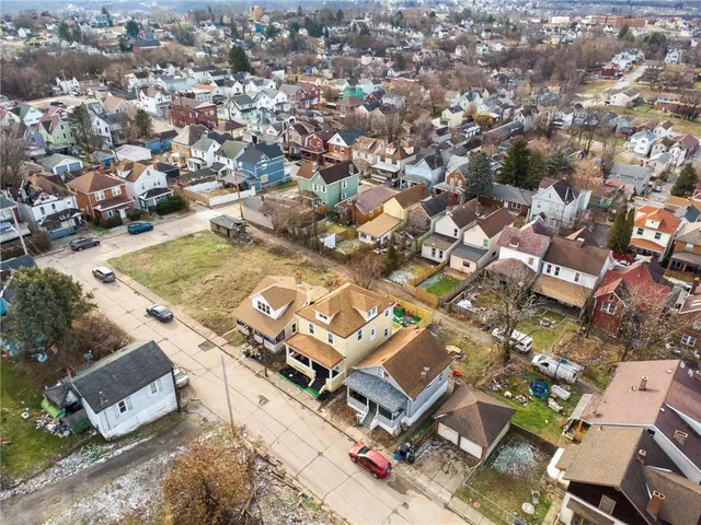an aerial view of a house with a yard