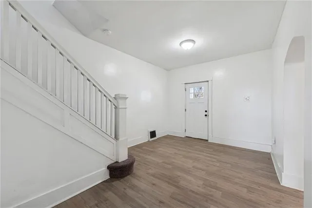 a view of an entryway with wooden floor