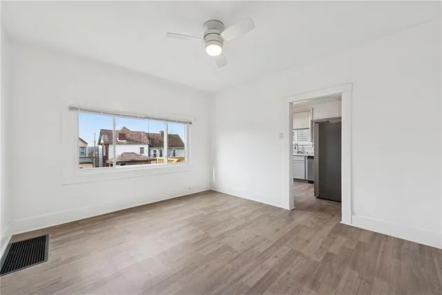 wooden floor in an empty room with a window
