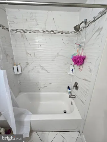a bathroom with a sink a toilet and shower curtain