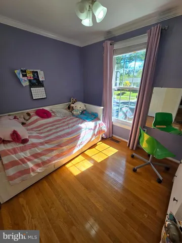 a bedroom with a bed and a television