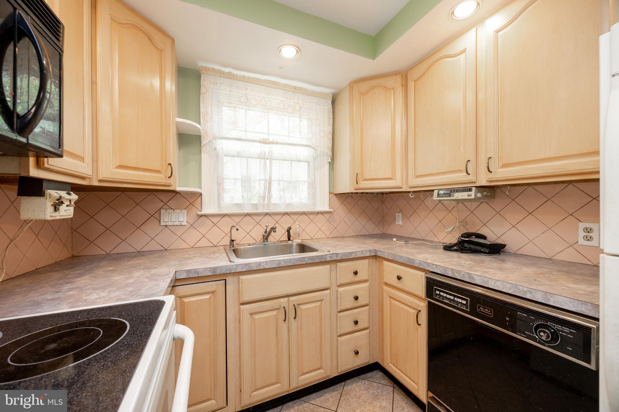 314 Spring Valley Road Springfield, PA 19064 - Photo 19 of 43 a kitchen with stainless steel appliances granite countertop a sink stove and cabinets