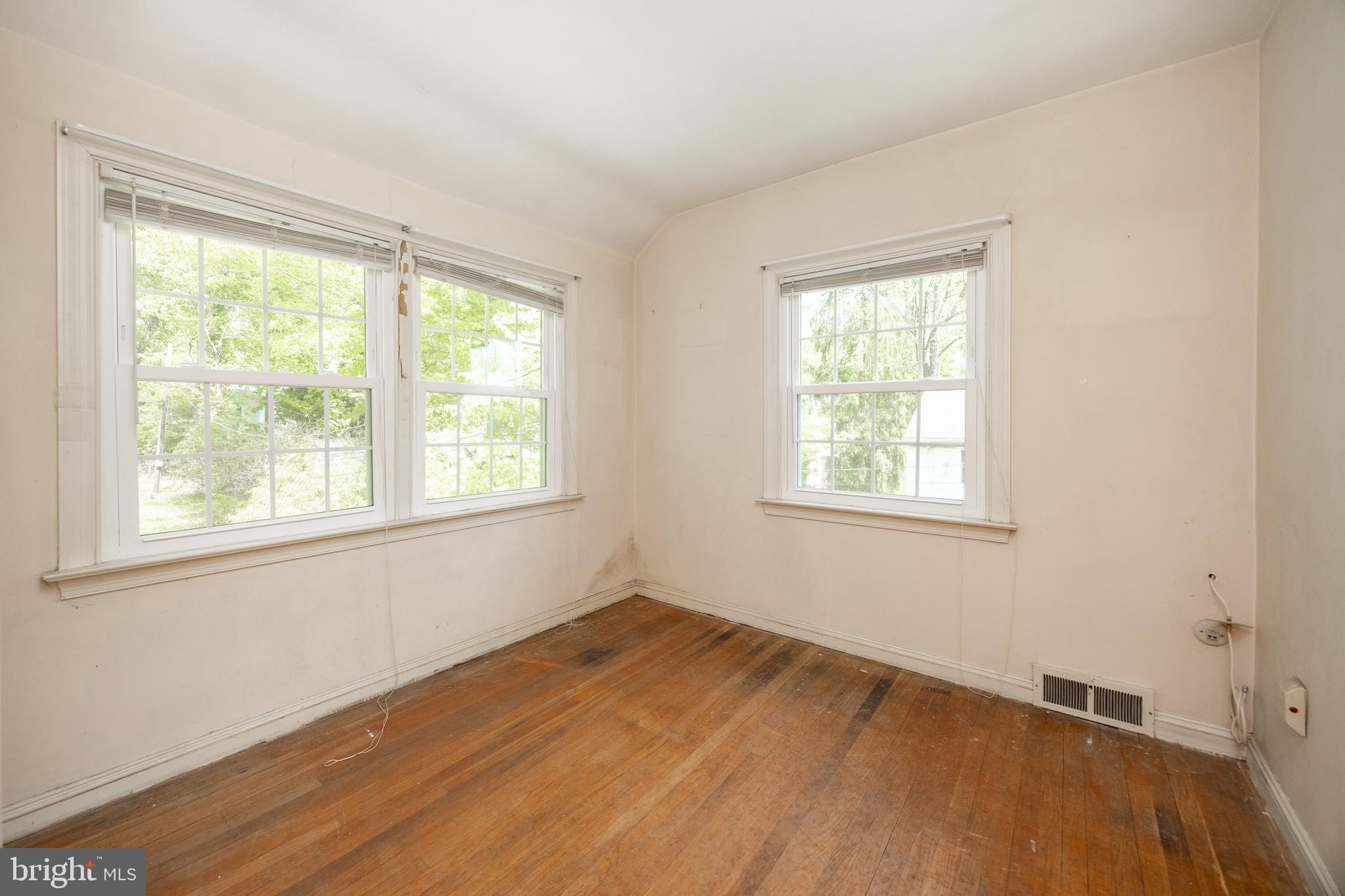 314 Spring Valley Road Springfield, PA 19064 - Photo 26 of 43 a view of an empty room with wooden floor and a window