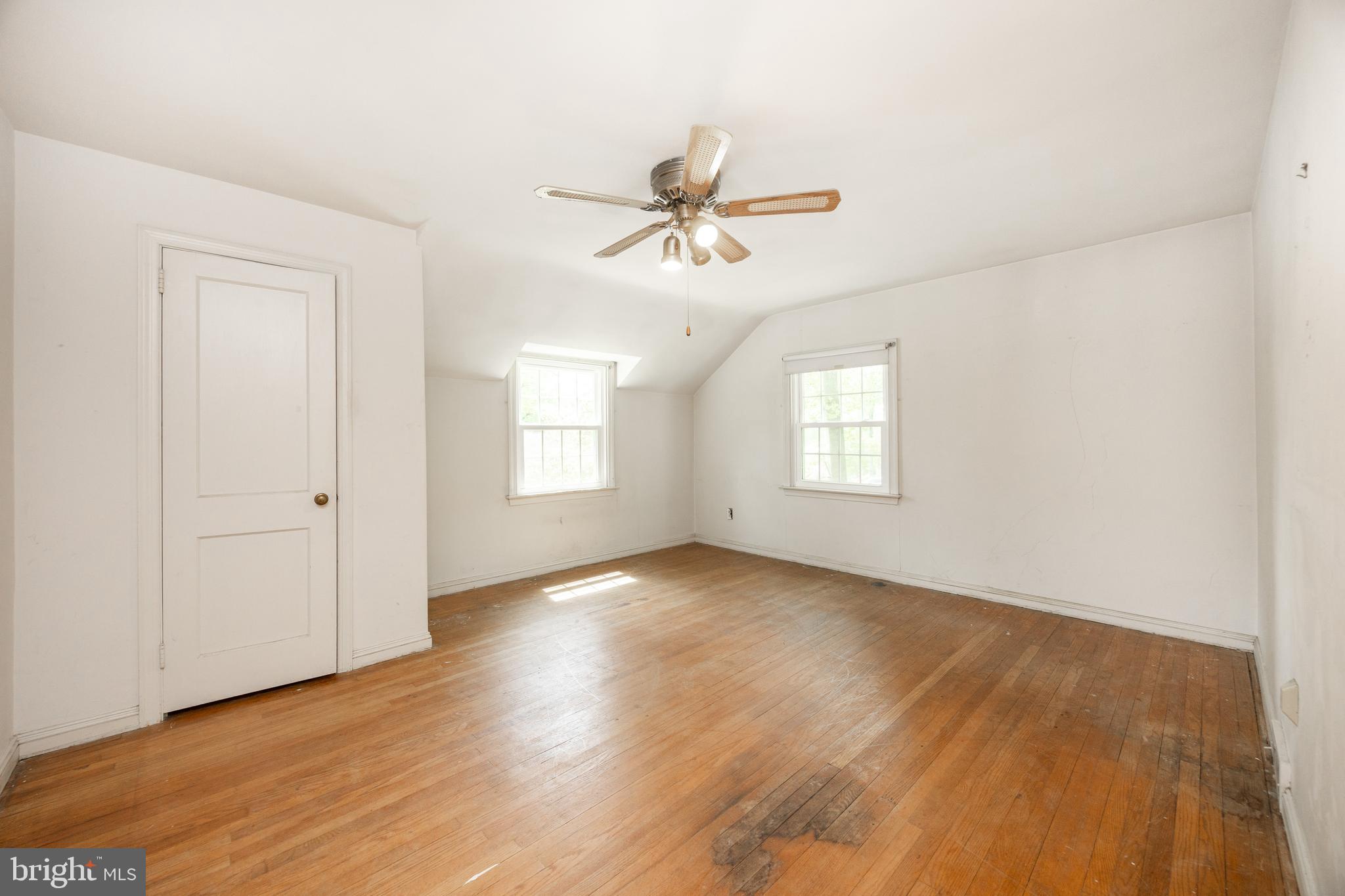 314 Spring Valley Road Springfield, PA 19064 - Photo 29 of 43 an empty room with wooden floor ceiling fan and windows