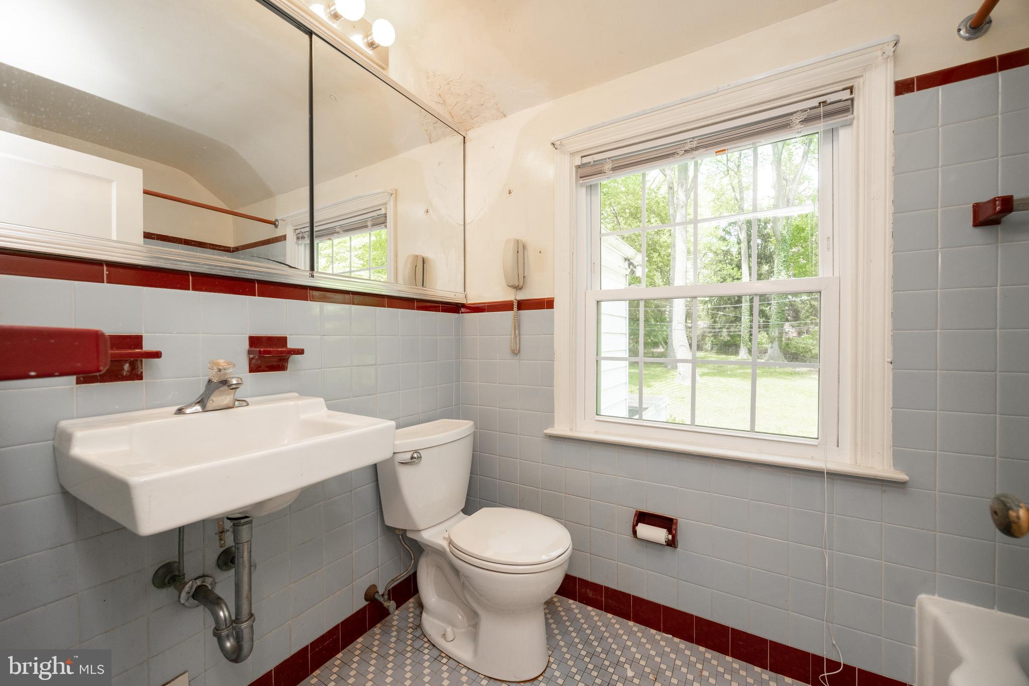 314 Spring Valley Road Springfield, PA 19064 - Photo 30 of 43 a bathroom with a sink a toilet and a window