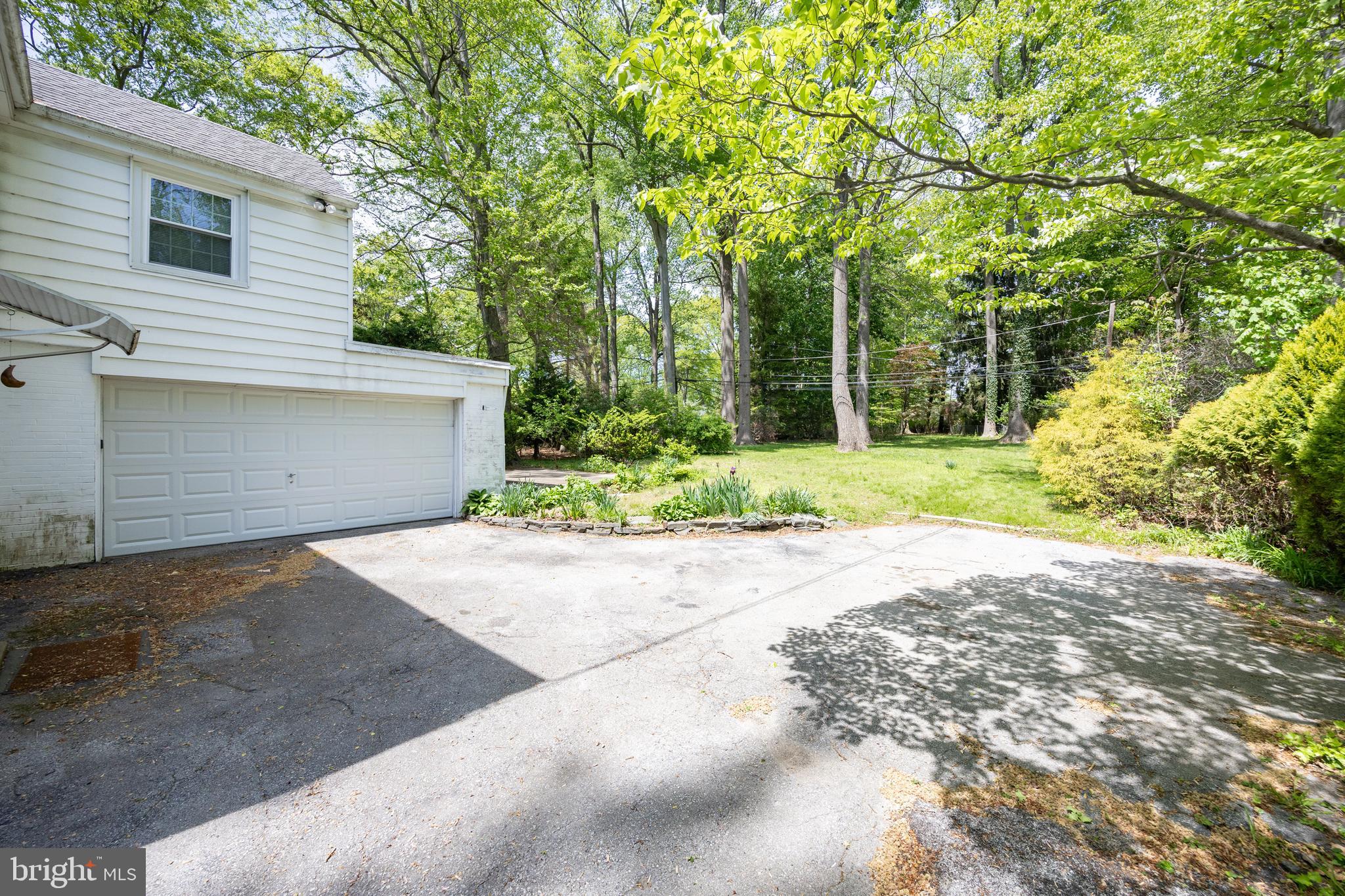 314 Spring Valley Road Springfield, PA 19064 - Photo 35 of 43 a front view of a house with a yard and a garage