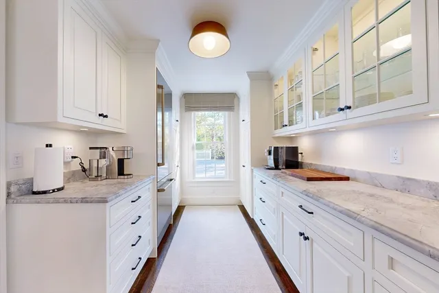 a kitchen with granite countertop a sink stove and cabinets