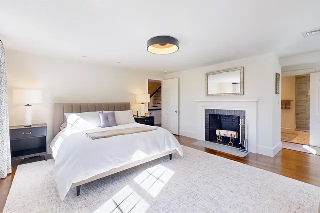 a spacious bedroom with a bed and a fireplace