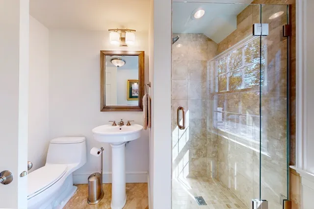 a bathroom with a sink toilet and shower