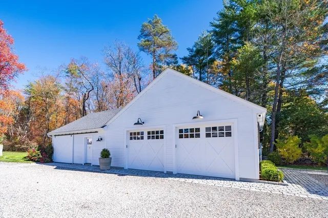 a view of a white house with a yard