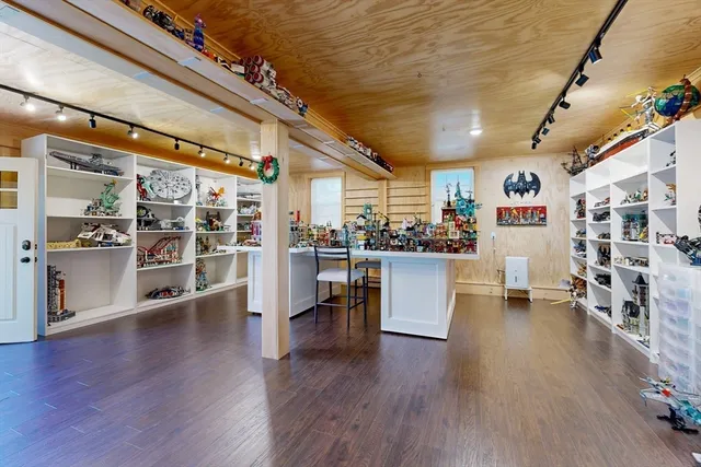 a kitchen with stainless steel appliances wooden floor and dining table