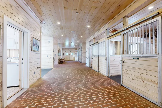 a view of a hallway with closet and cabinet