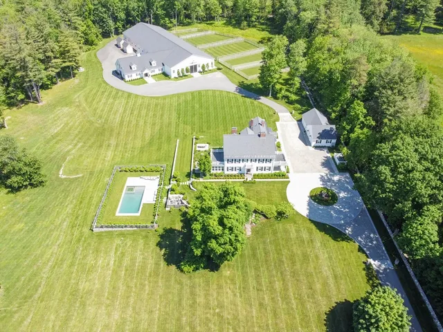 an aerial view of a house with a swimming pool