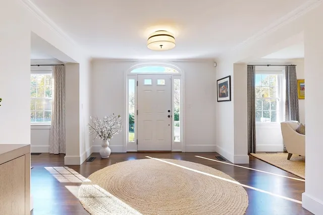 a view of an entryway with wooden floor