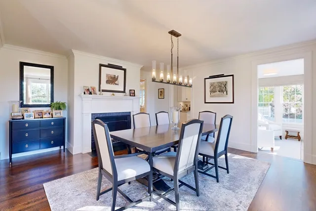 a view of a dining room with furniture a chandelier and wooden floor