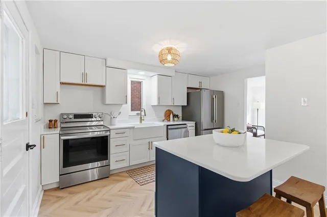 a kitchen with a sink appliances and cabinets