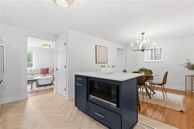 a view of kitchen with sink stove dining table and chairs