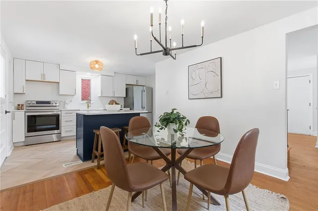a view of a dining room with furniture wooden floor and chandelier