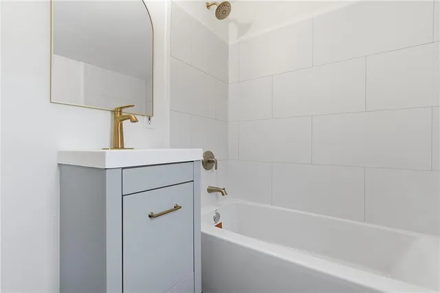 a bathroom with a bathtub and sink