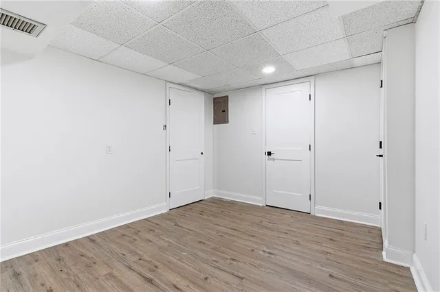 a view of an empty room with wooden floor