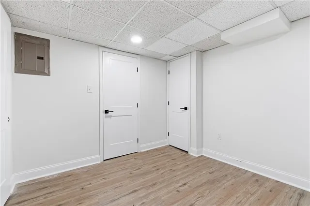 a view of an empty room with wooden floor