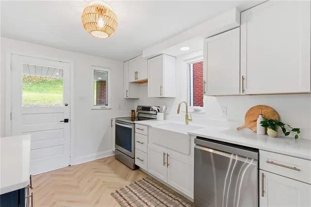 a kitchen with a sink cabinets and window