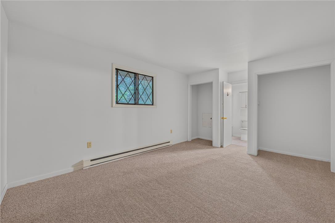 1570 Astolat Road Effort, PA 18330 - Photo 30 of 48 Plush carpeting anchors this versatile living space featuring diamond-pane window details.