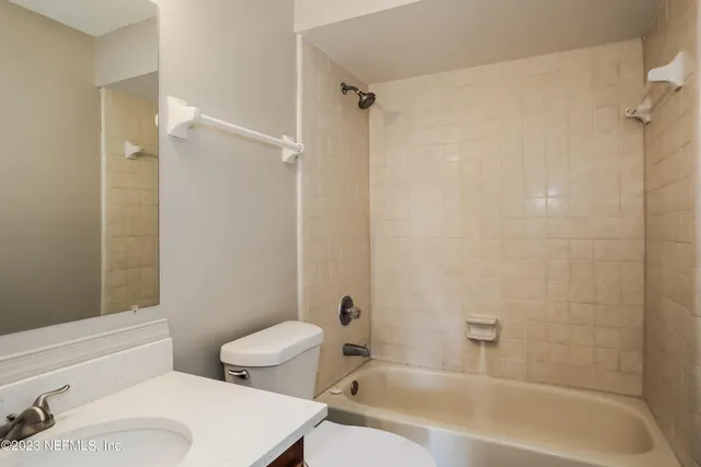 a bathroom with a toilet and a bathtub