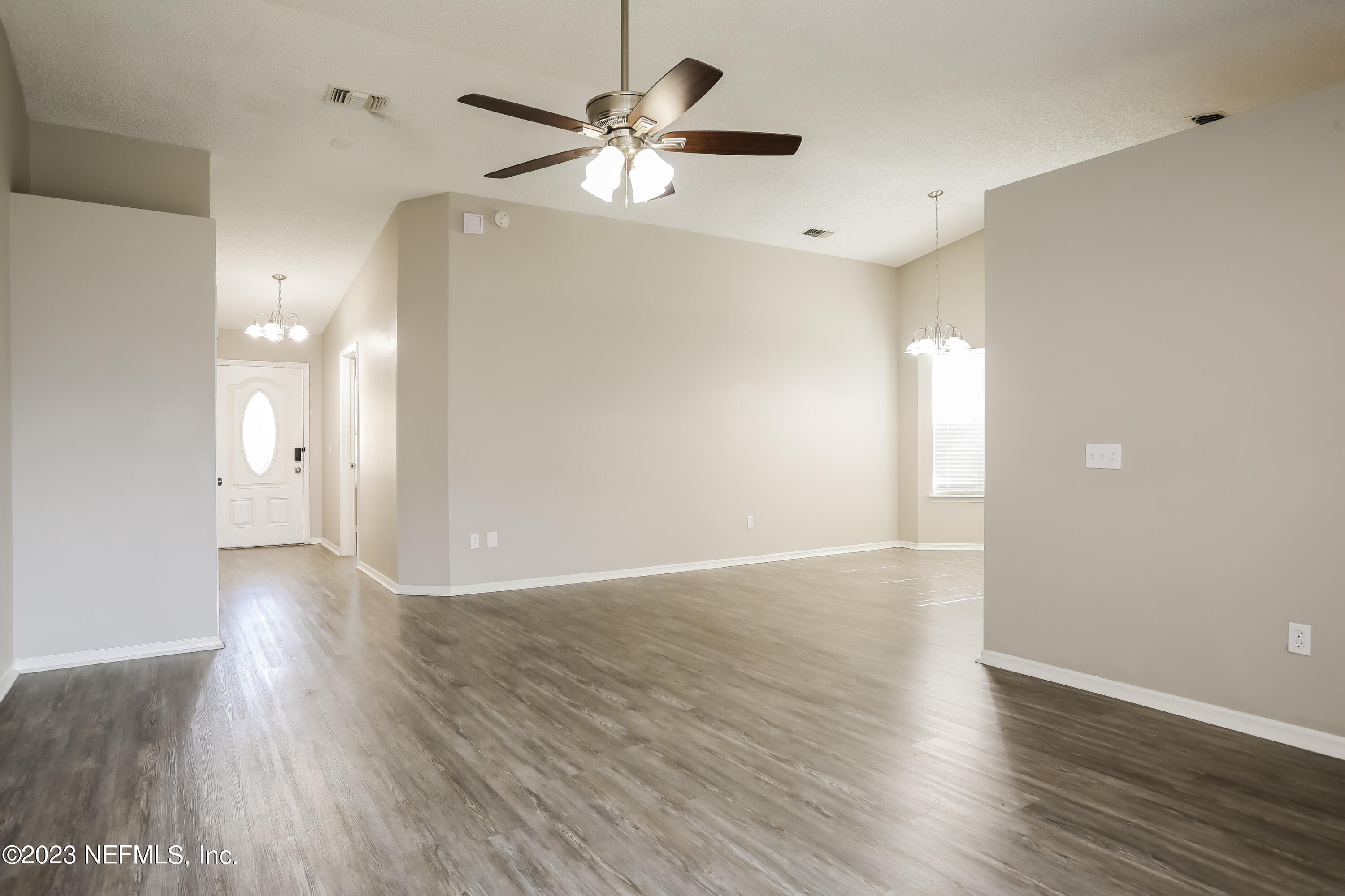 7684 Collins Ridge Boulevard Jacksonville, FL 32244 - Photo 3 of 15 a view of an empty room with wooden floor